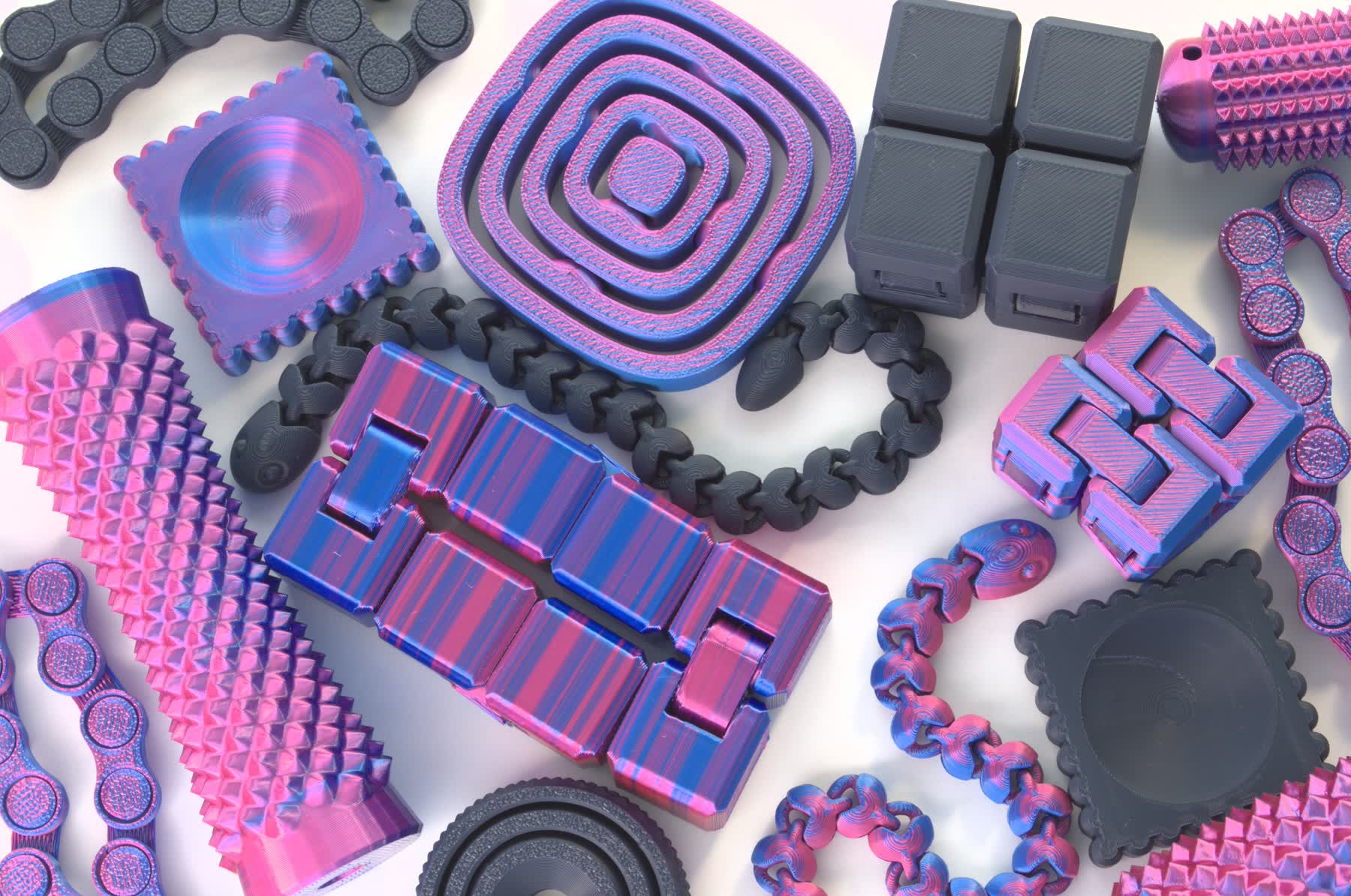 Fidget Street fidgets in Midnight Blue and Twilight Shine: infinity cubes, spiral mazes, chains, spiky rollers and clicker bars